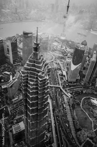 Breathtaking Aerial View above Jin Mao Tower in Shanghai, China surrounded by clouds Circa 2018 photo