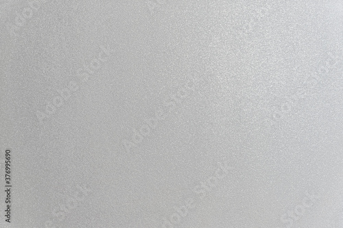 abstract background of an embossed painted grey wall close up