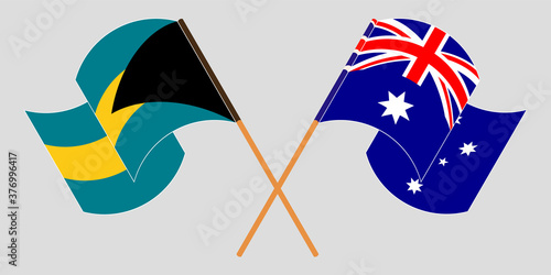 Crossed and waving flags of Bahamas and Australia
