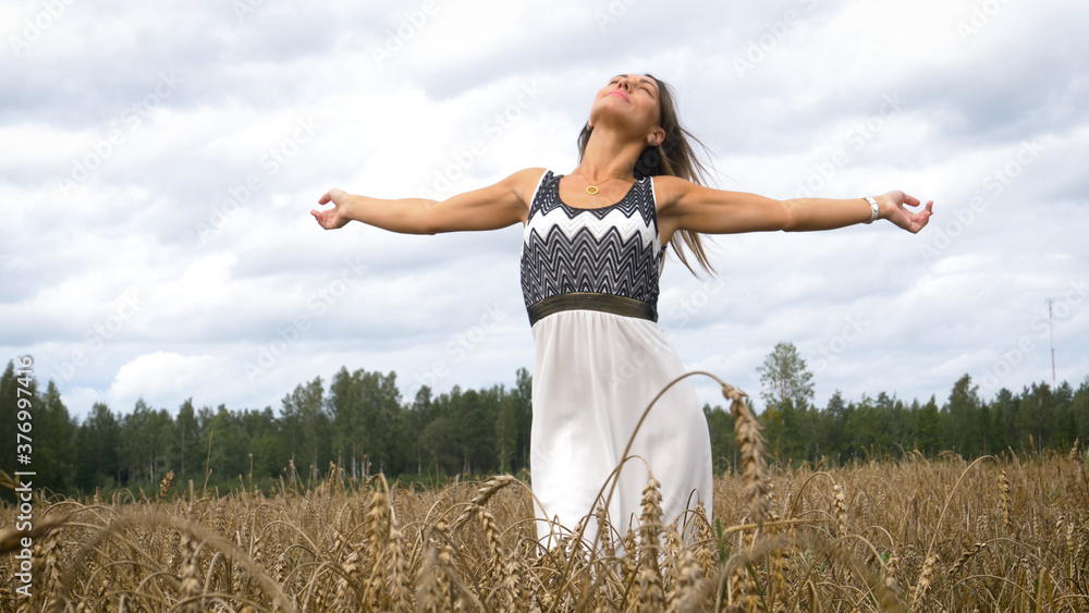 Portrait of a beautiful fashionable woman in a field of wheat harvest. Portrait of a beautiful fashionable woman in a field of wheat harvest.