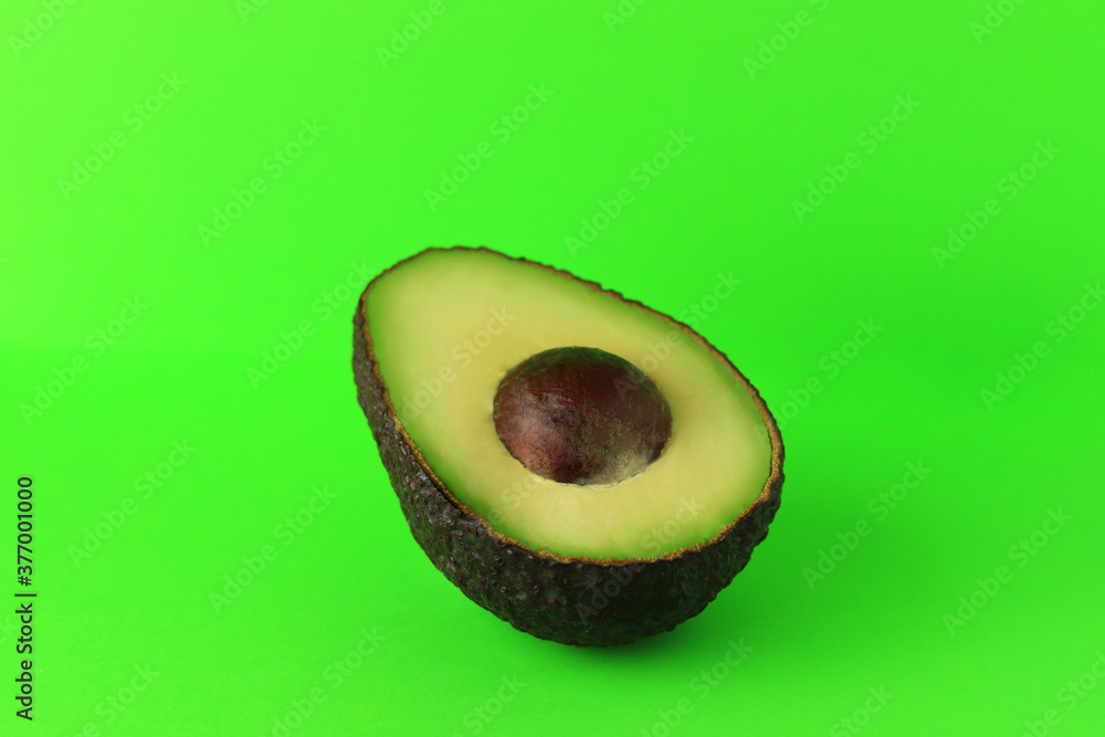 Avocado half isolated on green background. Fresh organic fruits and vegetables for healthy lifestyle concept Avocado half isolated on green background. Fresh organic fruits and vegetables for healthy lifestyle concept