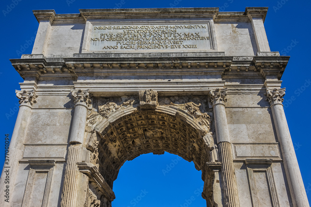 Right next to Colosseum stands Arch of Constantine, erected in early fourth century to celebrate victory of Constantine over Emperor Maxentius. Arch decorated with statues and reliefs. Rome. Italy.