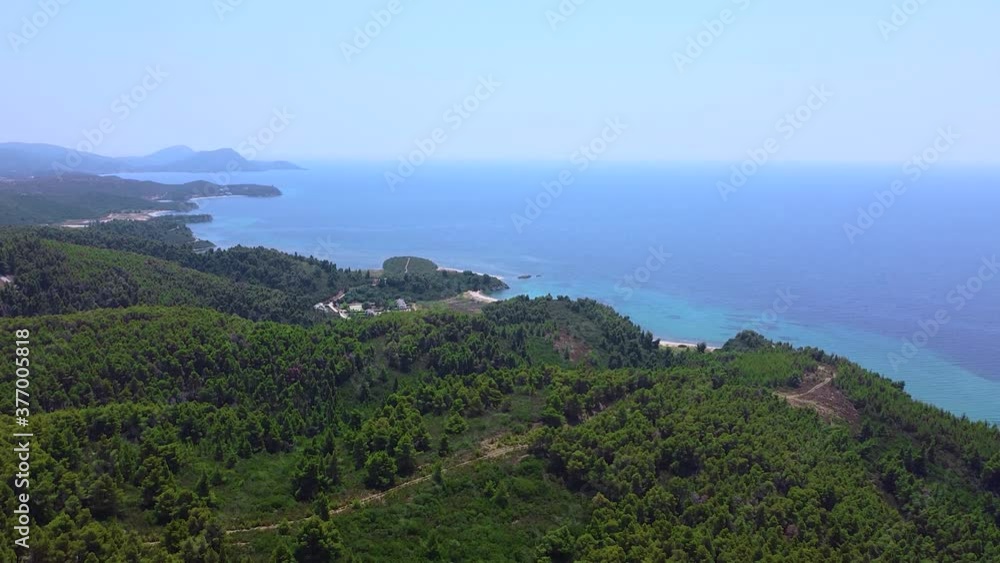 Aerial view of tropic blue open sea and coast with green pine trees Aerial view of tropic blue open sea and coast with green pine trees