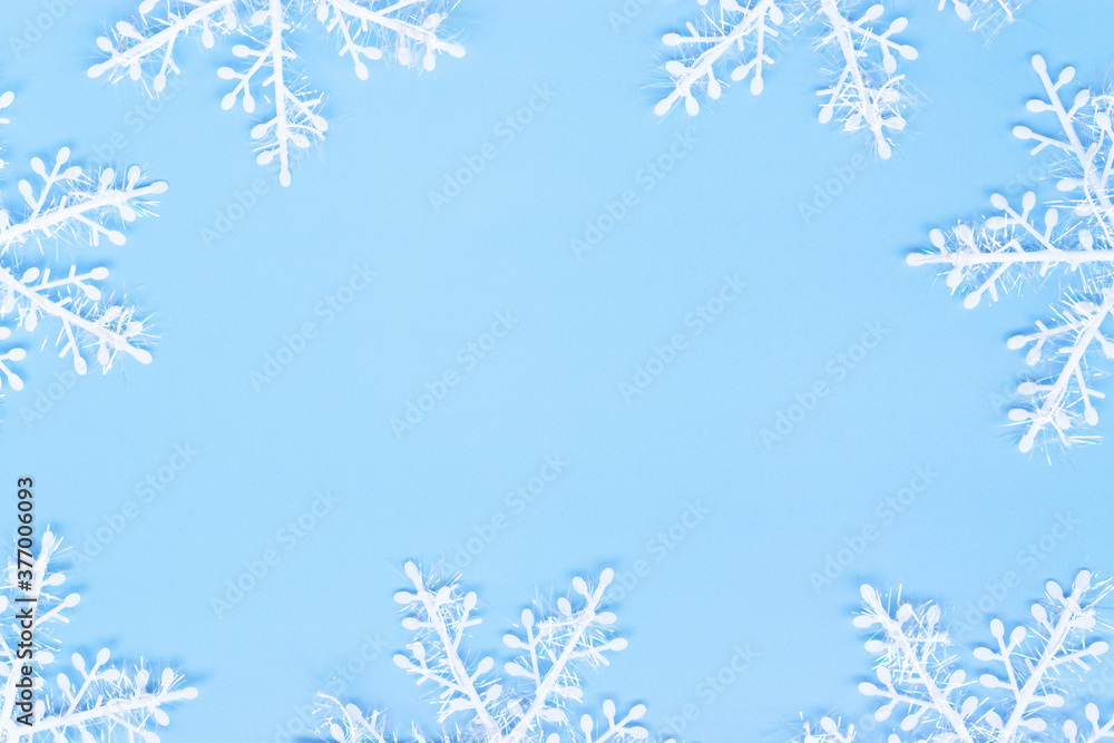Snowflakes on a blue background. New Year concept. Flat lay.