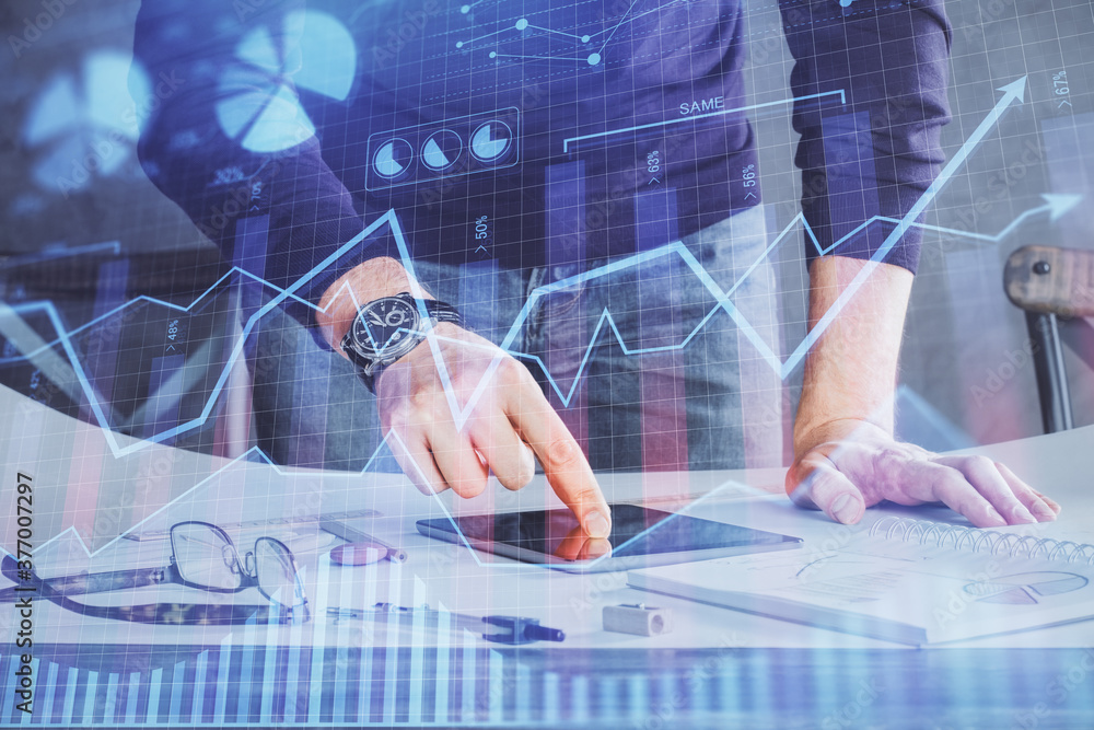 Double exposure of man's hands holding and using a digital device and forex graph drawing. Financial market concept. Double exposure of man's hands holding and using a digital device and forex graph drawing. Financial market concept.