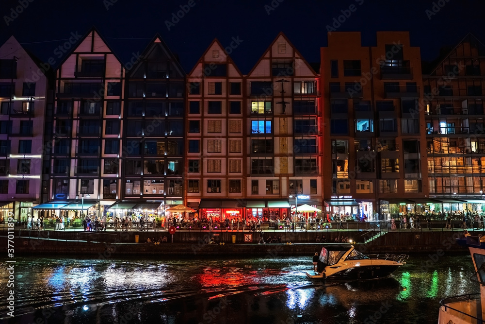 Gdansk, North Poland - August 13, 2020: Night photograph of medieval style polish architecture over motlawa river located in the old town near baltic sea