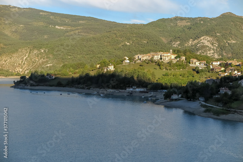 Lake of Castillion with blue melting water with surrounding forest mountains, commune of Saint-Julien-du-Verdon, Provence-Alpes-Côte d'Azur region, Alpes de Haute Provence, France
