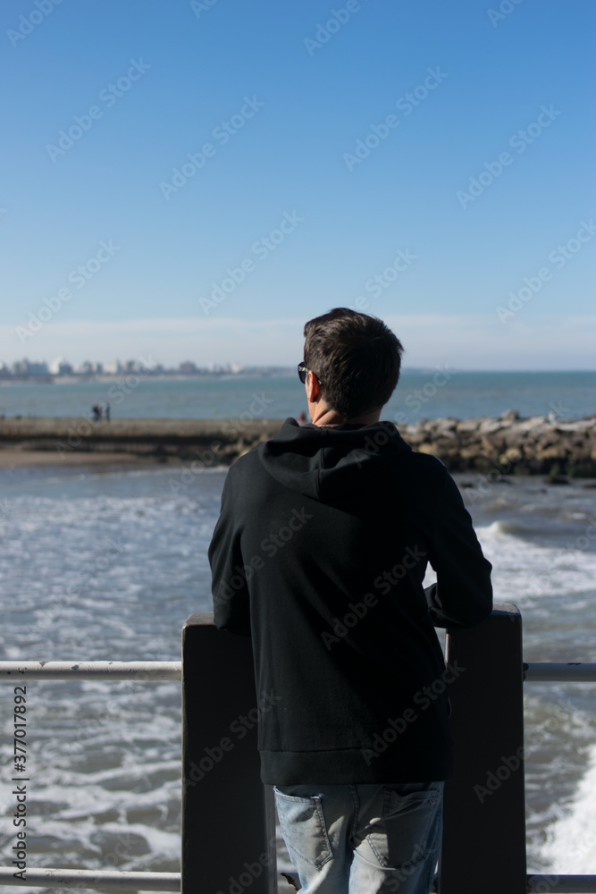 Young man with sky background summer campaign concept free social media communication, urban man advertising