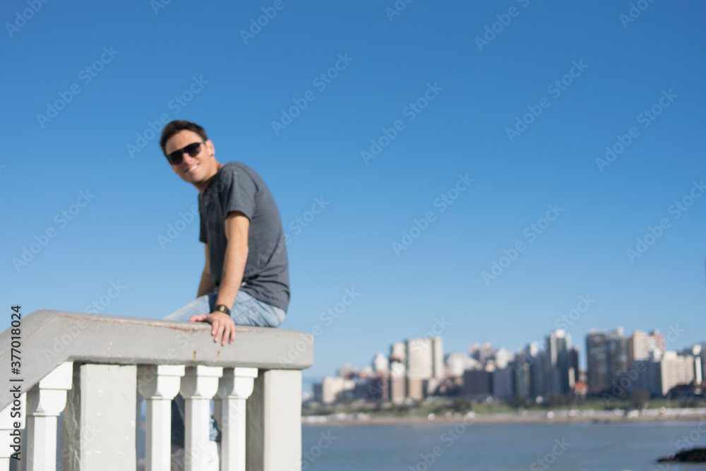 Young man with sky background summer campaign concept free social media communication, urban man advertising