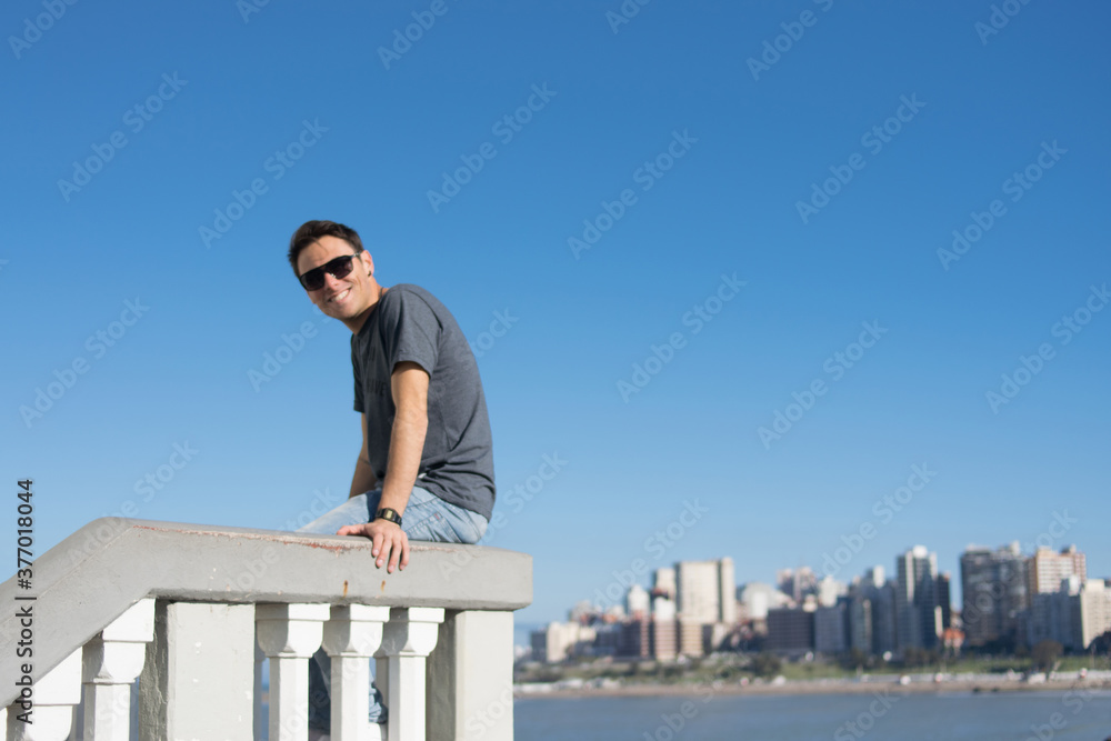 Young man with sky background summer campaign concept free social media communication, urban man advertising Young man with sky background summer campaign concept free social media communication, urban man advertising