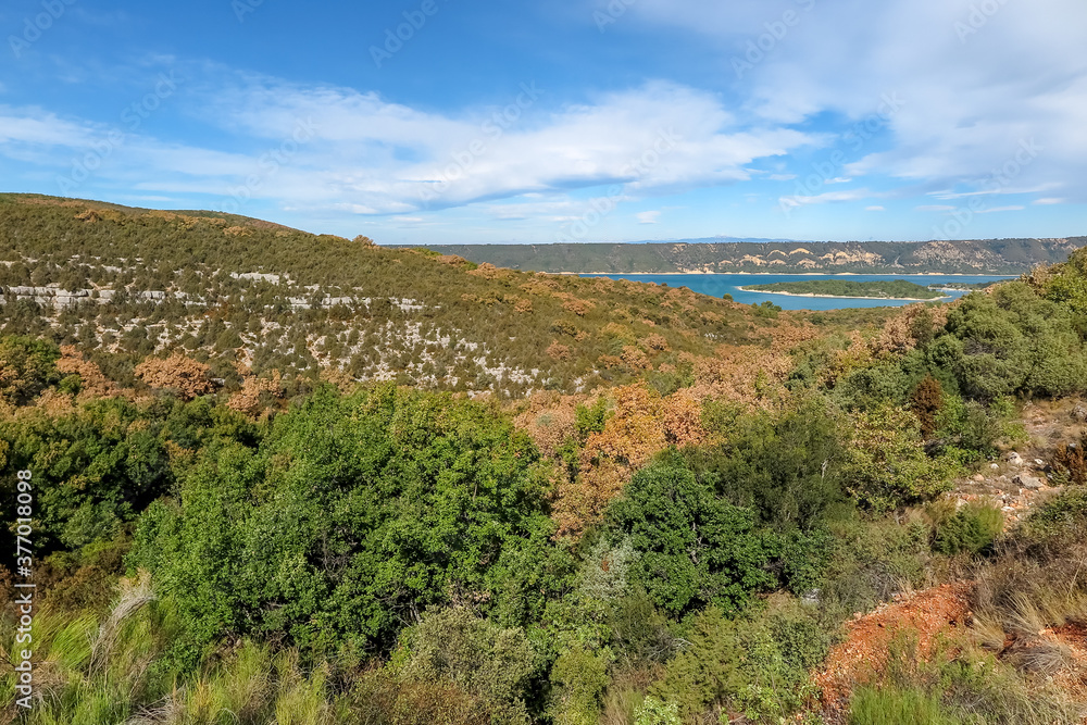 Lake of Sainte-Croix with blue melting water with forest mountains around, commune of Les Salles-sur-Verdon, region of Provence-Alpes-Côte d'Azur, Alpes de Haute Provence, France