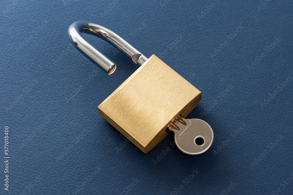 Unlocked golden padlock on the blue background. Unlocked golden padlock on the blue background.