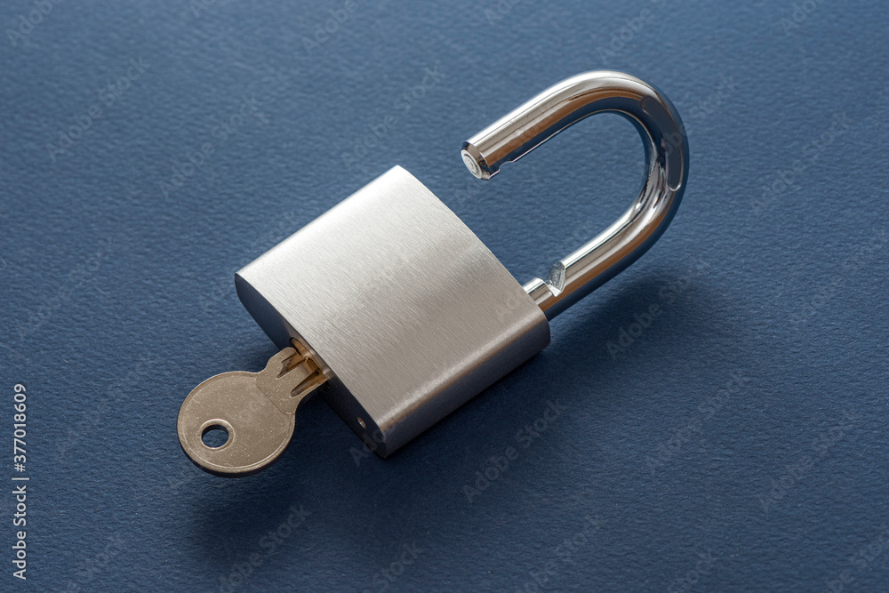 Unlocked silver padlock on the blue background. Unlocked silver padlock on the blue background.