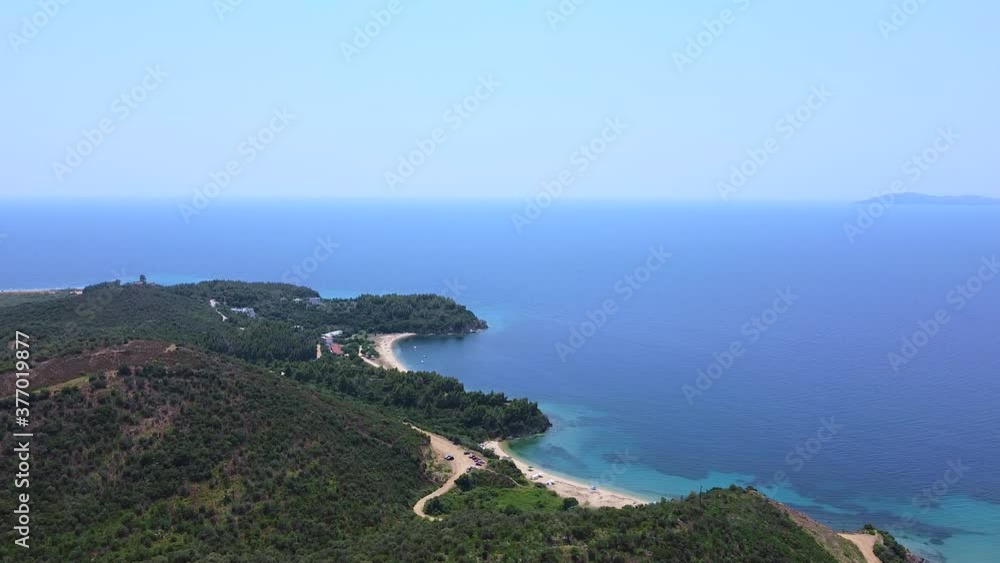 Drone flight over the tropic blue open sea and coast with green pine trees Drone flight over the tropic blue open sea and coast with green pine trees