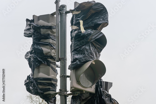 Old broken traffic light covered with film