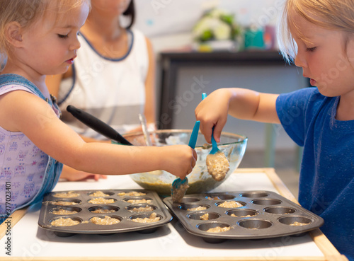 Children learning in the kitchen. Baking cooking class at home. photo