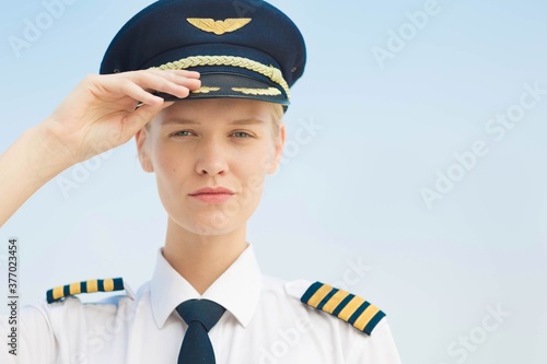 A female pilot captain at the airport, portrait. Aviation. photo