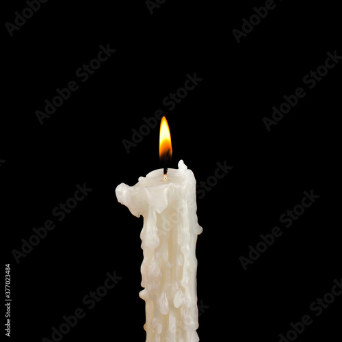 Burning candle on a black background.