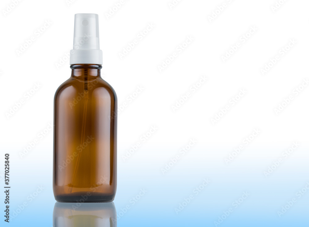 Amber glass bottle with spray. Blue background gradient with reflection. Mockup and copy space available. Amber glass bottle with spray. Blue background gradient with reflection. Mockup and copy space available.