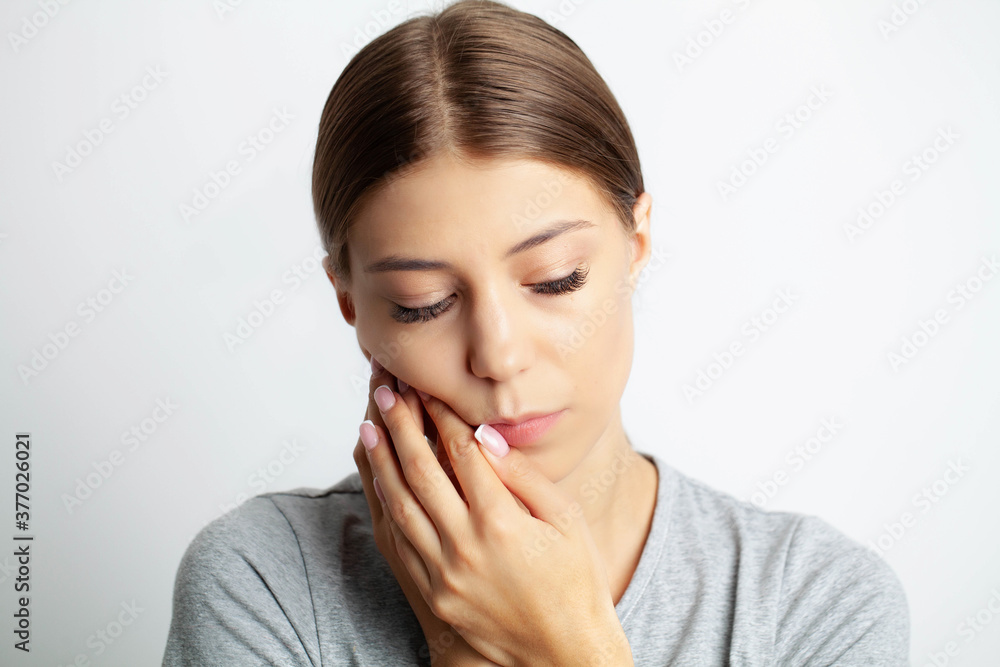 Close up of a beautiful young woman experiencing a painful toothache Close up of a beautiful young woman experiencing a painful toothache