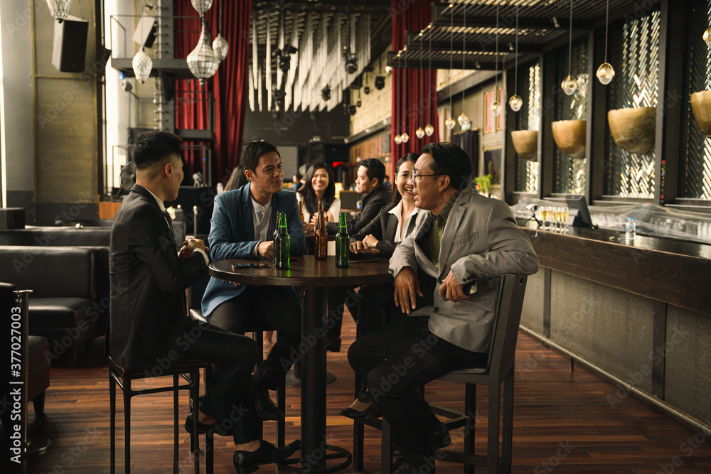 businesspeople having fun drinking beer and talking together
