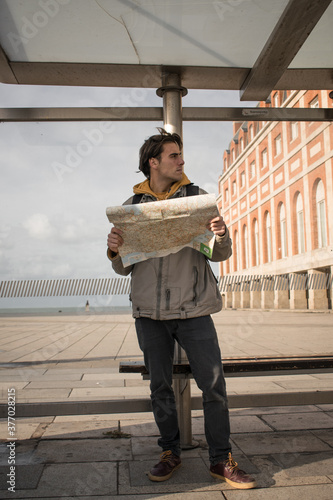 young man with map travel concept vacation adventure travel advertising gps campaign, airport opening, public transport, transportation, maps