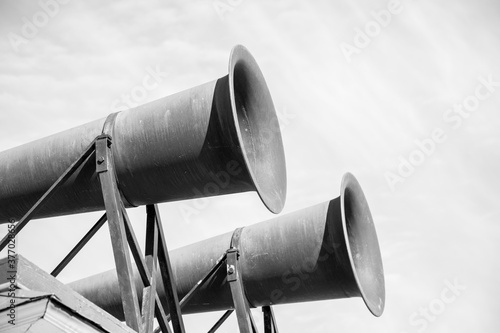 Foghorns near lighthouse black and white