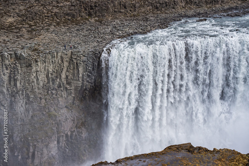 Two men walking to Dettifoss waterfall in Iceland.