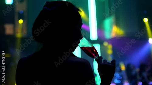 Attractive young girl having fun dancing in club. Nightlife and disco concept. photo