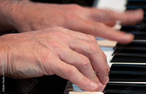 hands of a person playing the piano