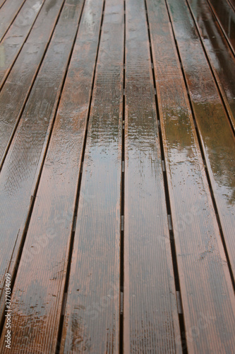 raining on wet wooden floor with reflection