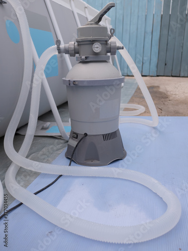 latest modern sand pump model for frame pool for children and adults in country house. concept of accessories for family vacations and active lifestyle after quarantine