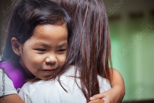 Asian child girl is hugging her mother and getting ready for school.