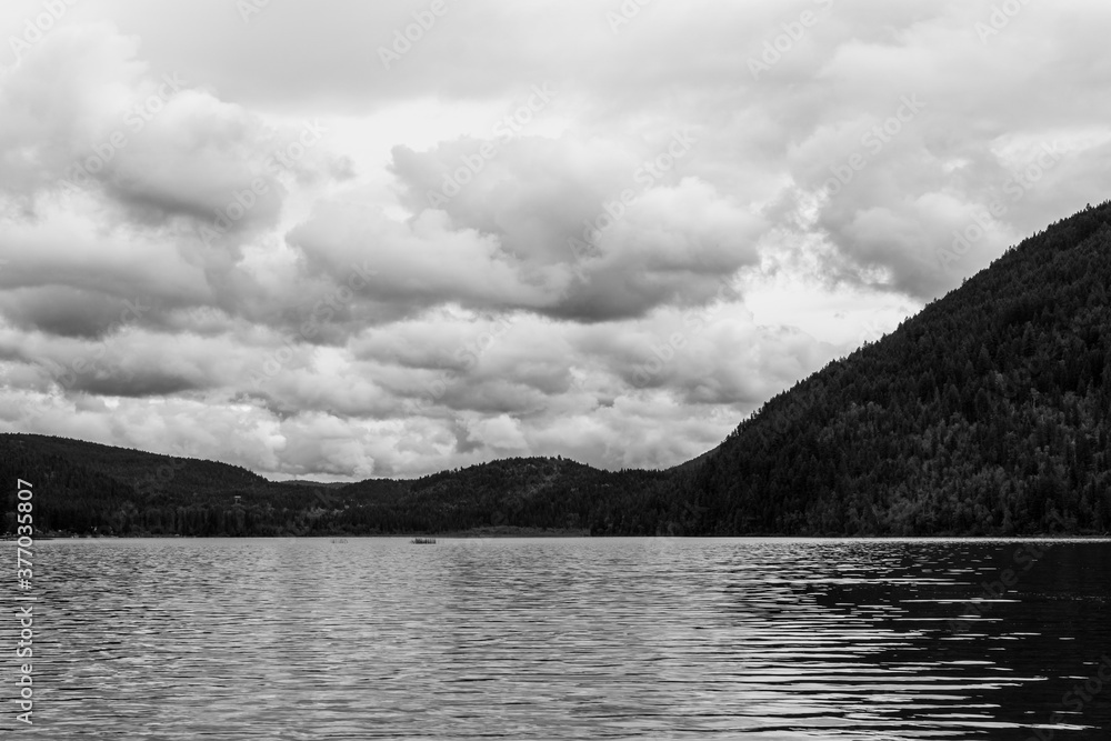 black and white Paul Lake Summer time with mountains and clouds british columbia canada.