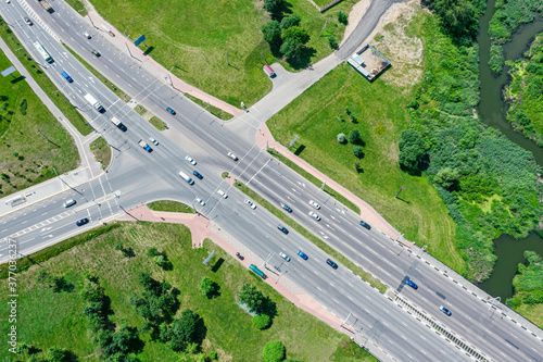 aerial drone view of suburban street intersection with car traffic in sunny day © Mr Twister