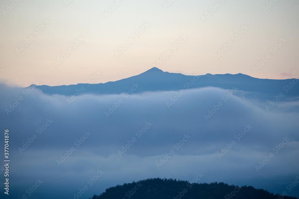 mountain pick fog clouds on mitsikeli mountain , ioannina perfecture , greece