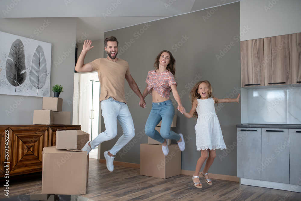 Young cute family jumping and looking excited Young cute family jumping and looking excited