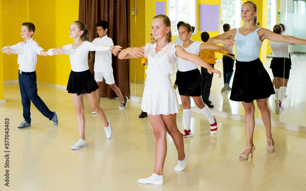 Group of children learn dance movements in dance class
