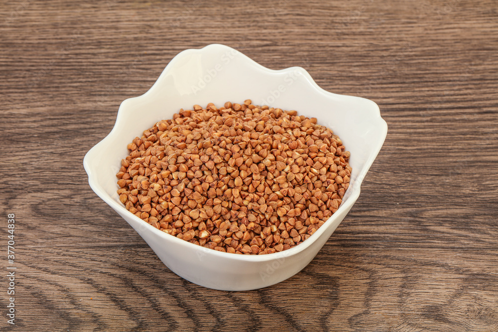 Raw buсkwheat cereal in the bowl Raw buсkwheat cereal in the bowl