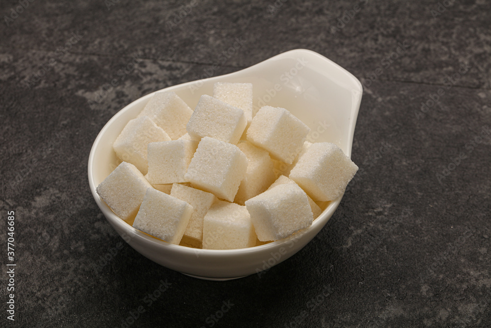 Refined white sugar cubs in the bowl Refined white sugar cubs in the bowl
