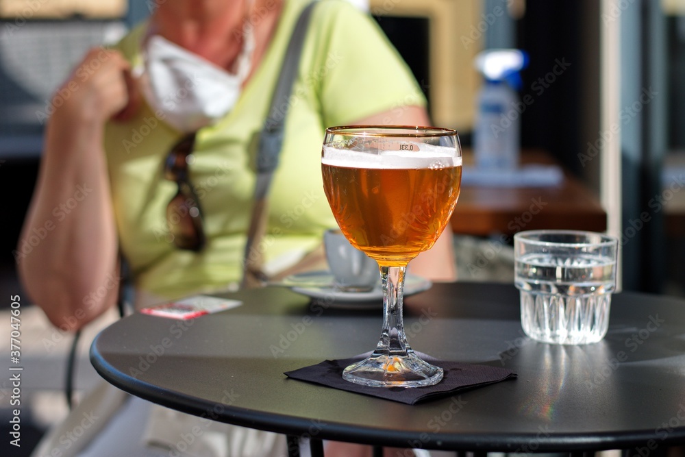 Closeup of a glass with fresh cold beer on a table Closeup of a glass with fresh cold beer on a table