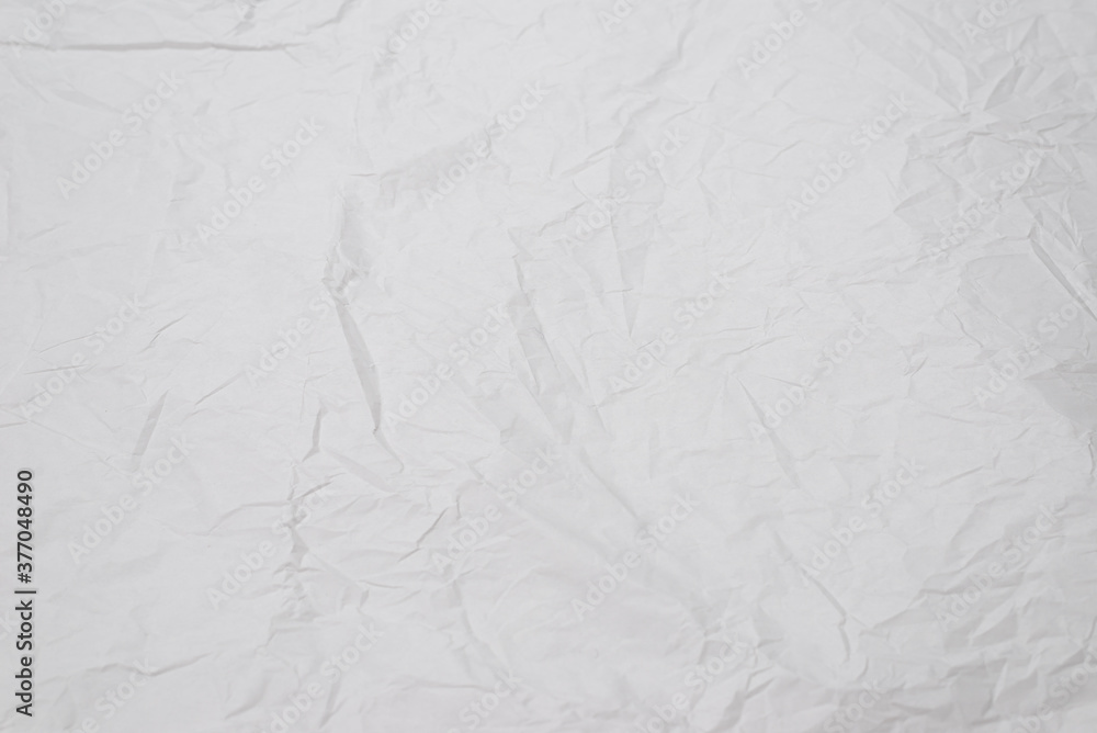 Crumpled white paper background.