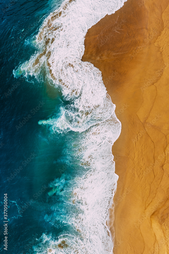 Beautiful sea wave. Clean beach with beautiful yellow sand and turquoise sea, vertical photo. Beautiful seascape, view from the height. Beautiful sandy beach, top view. The ocean and beach. Copy space Beautiful sea wave. Clean beach with beautiful yellow sand and turquoise sea, vertical photo. Beautiful seascape, view from the height. Beautiful sandy beach, top view. The ocean and beach. Copy space