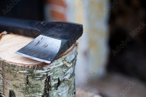 Fototapeta Naklejka Na Ścianę i Meble -  Siekiera leżąca na sosnowym pieńku.