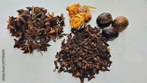Dried cloves, nutmeg and star aniseed in white background 