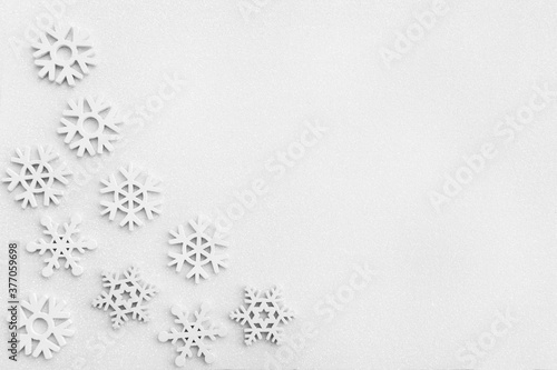 Christmas frame made of snowflakes on white sparkle background.