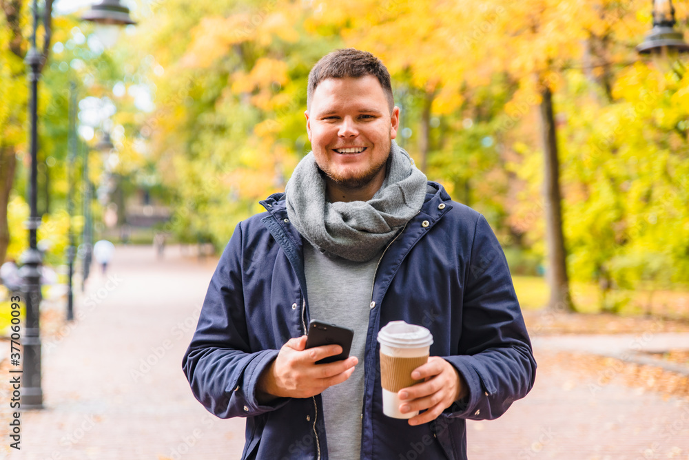 man drinking coffee outdoors autumn season talking on the phone man drinking coffee outdoors autumn season talking on the phone