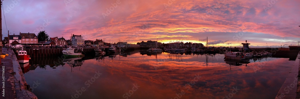 Dramatic pink sunset at harbor in Northern France