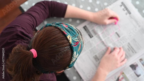 Unemployed woman searching for job in a newspaper. 