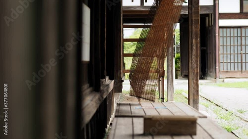 日本の古民家の縁側と風に揺れる簾。日本の夏の風景。